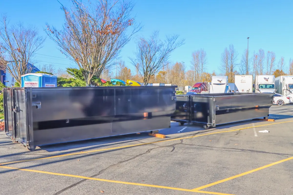 Professional dumpster rental service with roll-off container on residential driveway in Schuyler